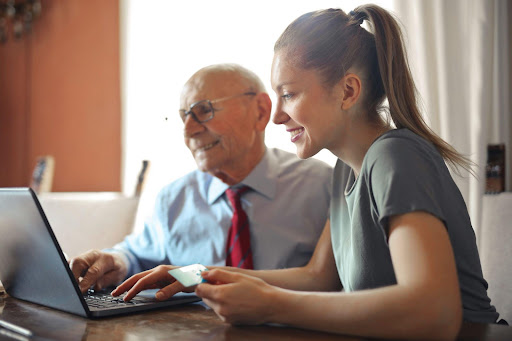 A businessman and woman on a laptop