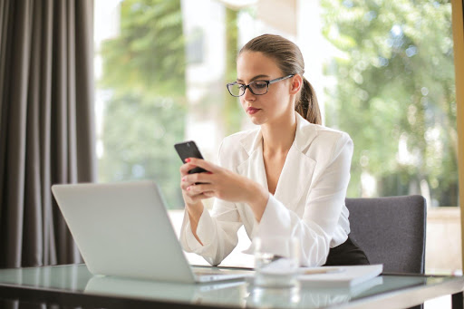 A businesswoman texting
