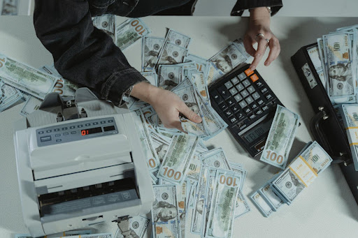 Man working with a calculator and money